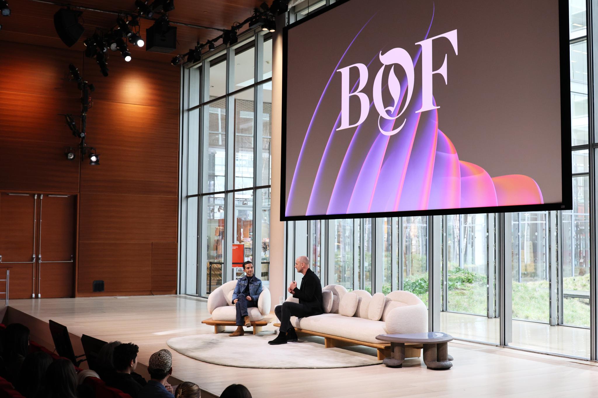 Two speakers on stage at the BoF Professional Summit beneath a large BoF screen