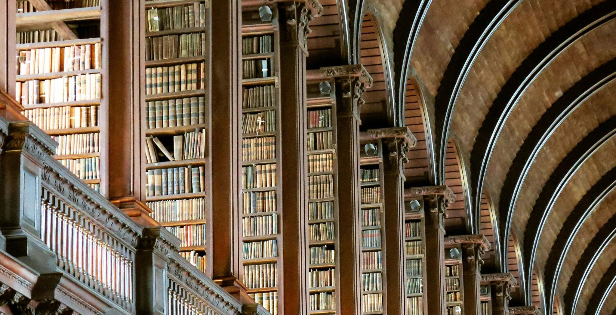 Tall bookshelves and arched ceilings inside a historic library
