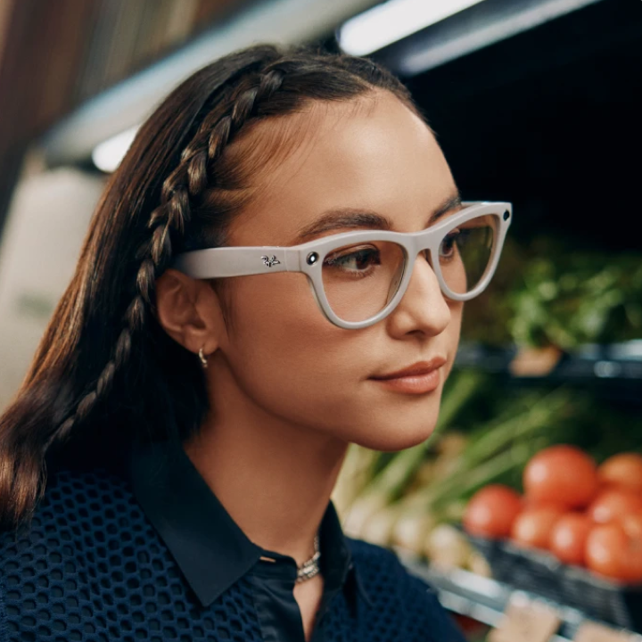 Woman wearing white smart glasses near produce shelves