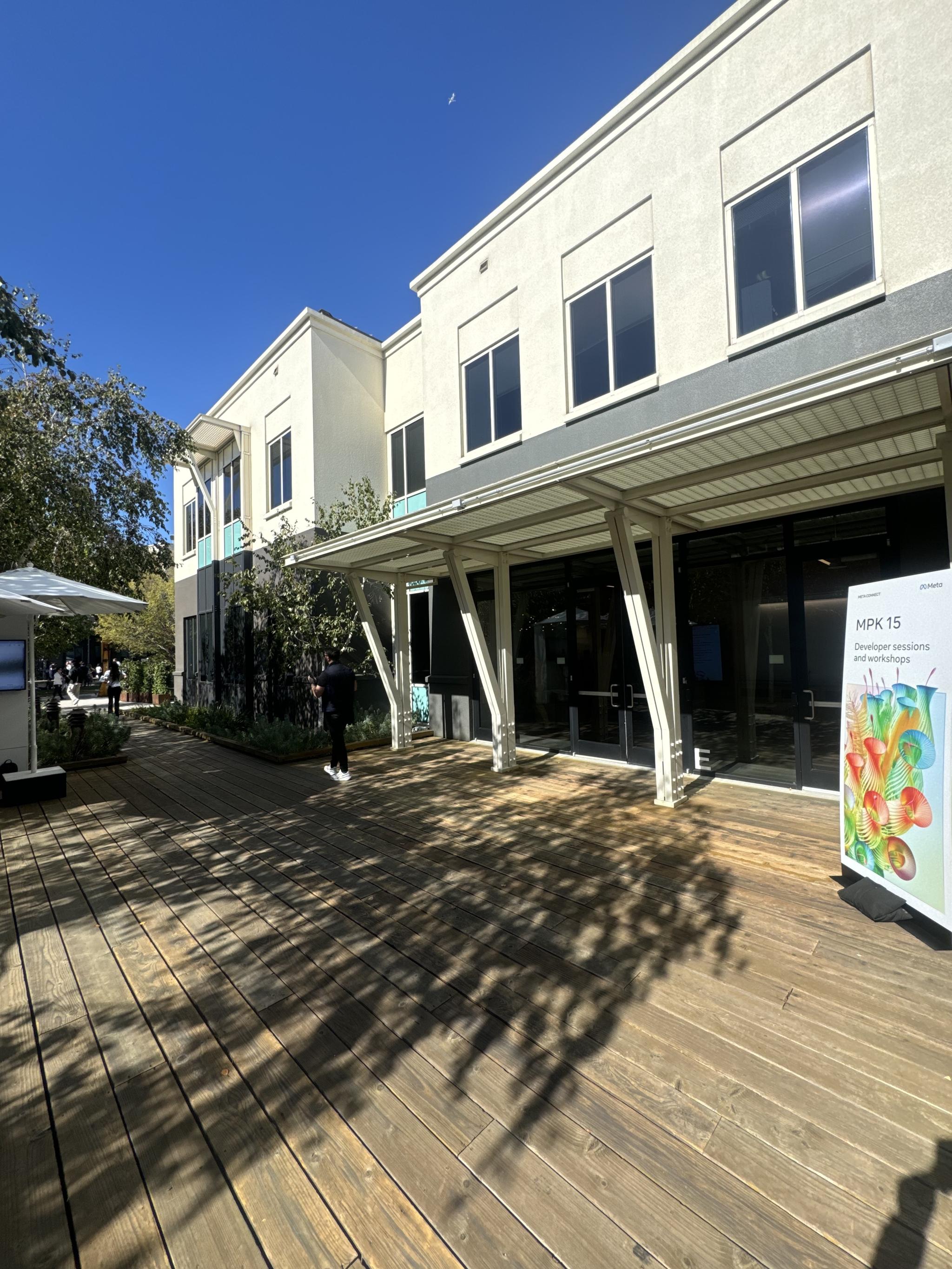 Sunlit building exterior with MPK 15 developer sessions sign