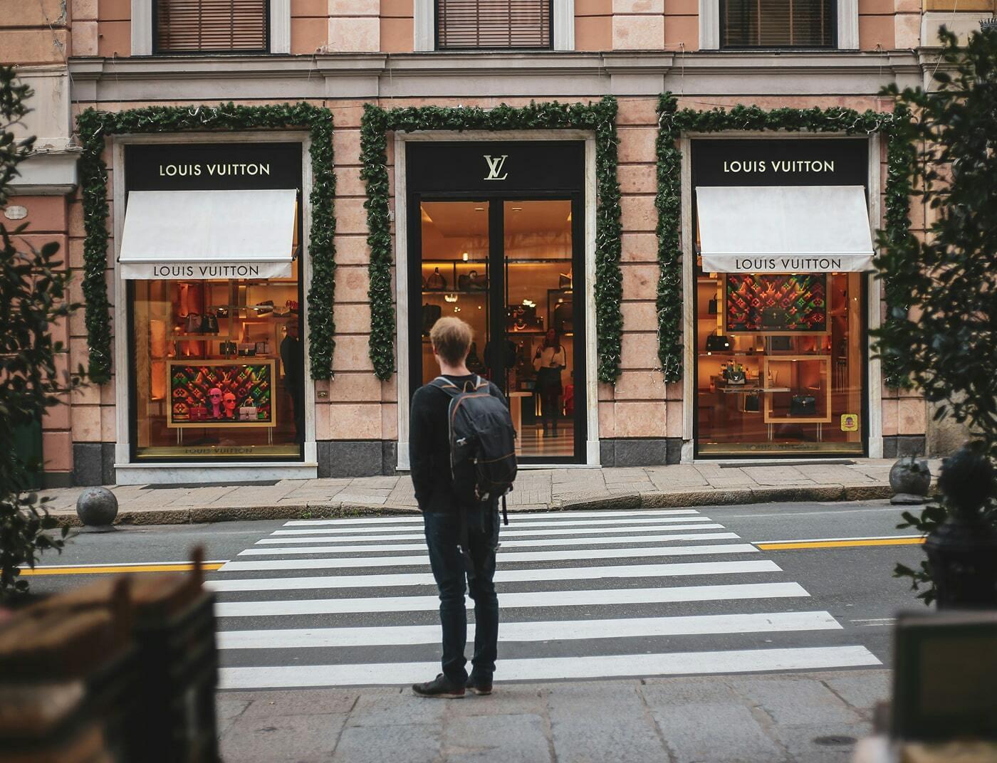 Person standing across from a Louis Vuitton storefront