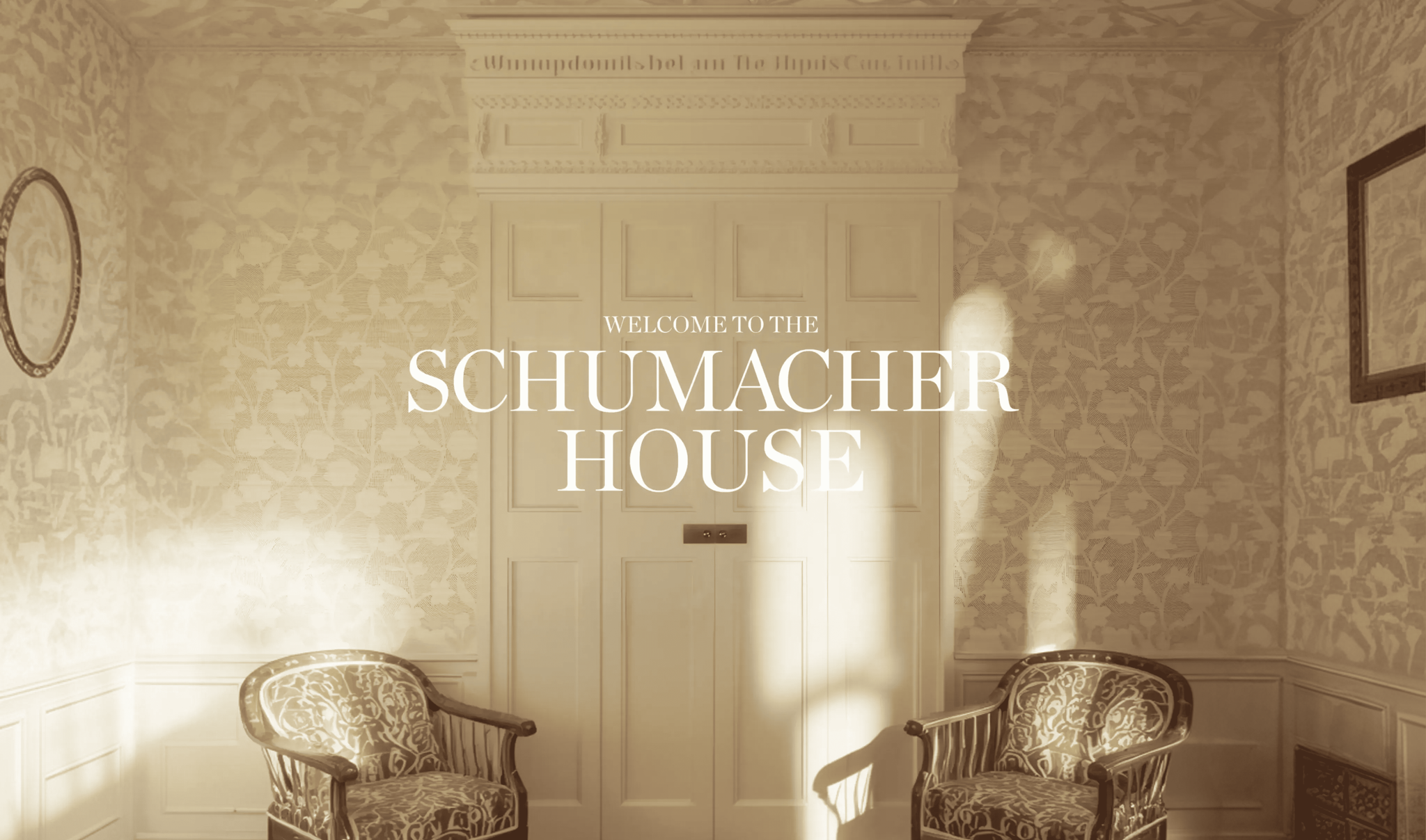Welcome to the Schumacher House title over a sunlit vintage room with patterned walls and chairs