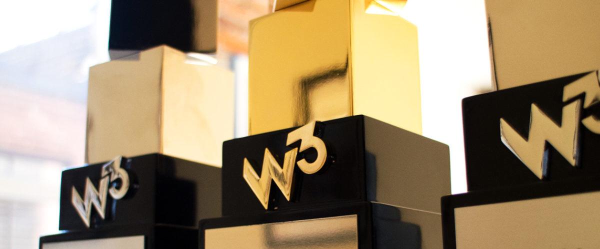 W3 award trophies with black and gold geometric designs on display