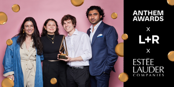Group of four holding an award beside Anthem Awards, L+R, and Este Lauder logos