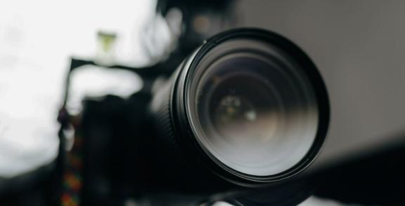 Close-up of a camera lens with a blurred background