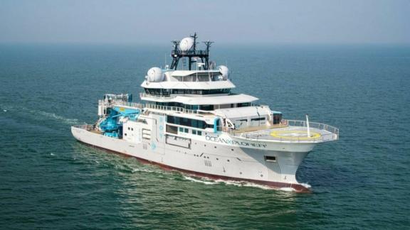 Large white research vessel sailing on the ocean
