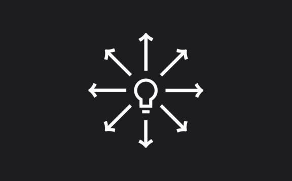 White lightbulb icon with arrows radiating outward on a dark background