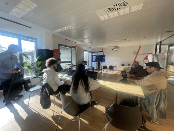 People seated around a conference table in a bright office meeting room