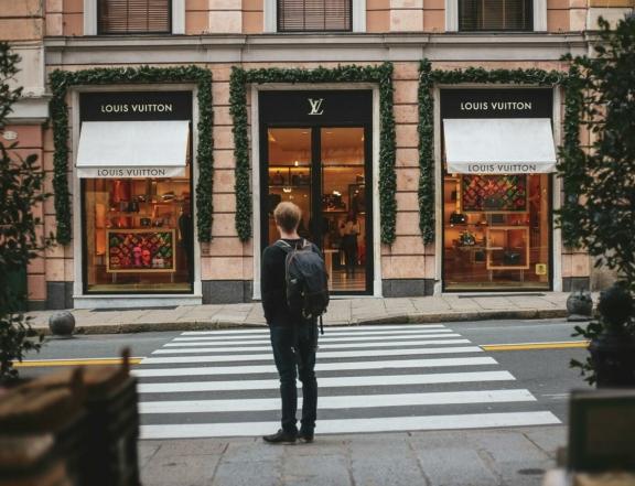 Person standing across from a Louis Vuitton storefront