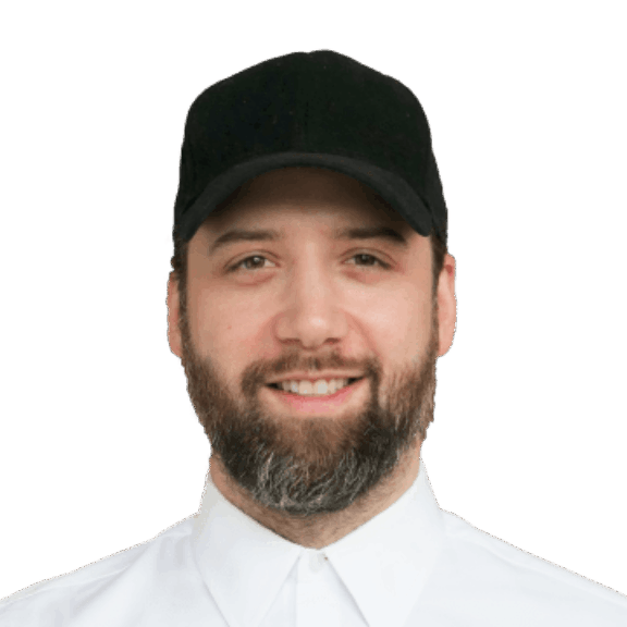 Bearded man wearing a black cap and white buttoned shirt on a green background