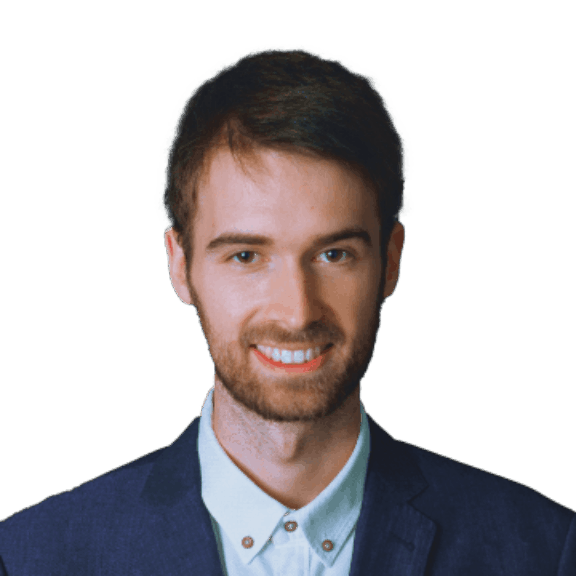Smiling man in a blue suit jacket and white shirt on a green background