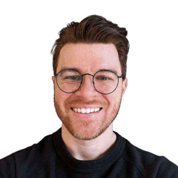 Smiling man with glasses and reddish hair in a dark sweatshirt on a green background