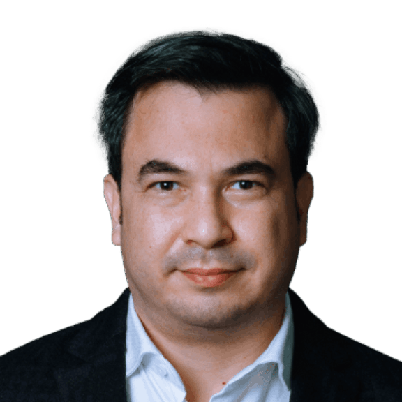 Head-and-shoulders portrait of a man in a dark blazer and white shirt on a green background