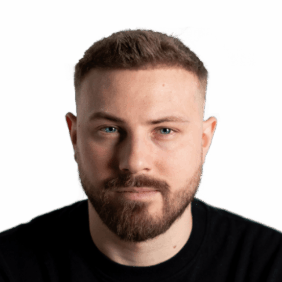 Bearded man with short hair in a black shirt on a green background