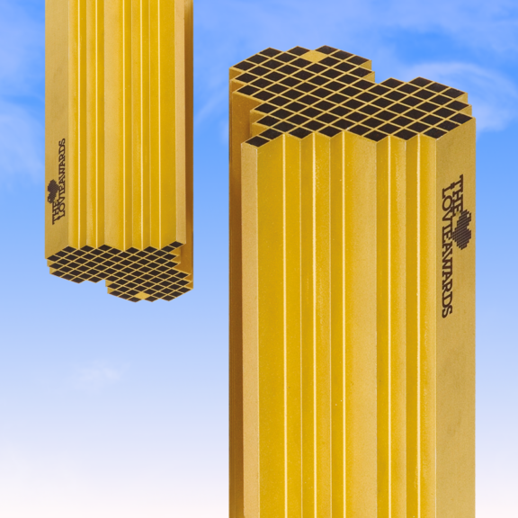 Yellow Hot Awards trophy pillars against a blue sky