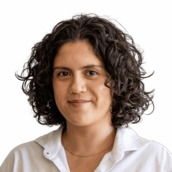 Woman with short curly hair in a white collared shirt on a green background