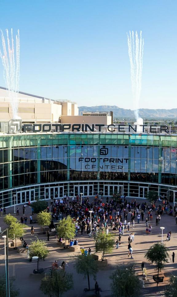 Footprint Center arena entrance with crowds outside and Valley Proud banners