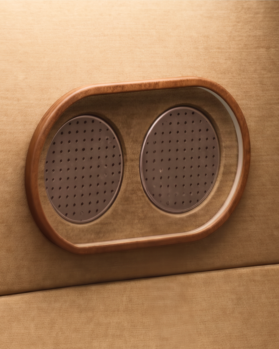 Headphones rest on a cushioned surface under warm red light.