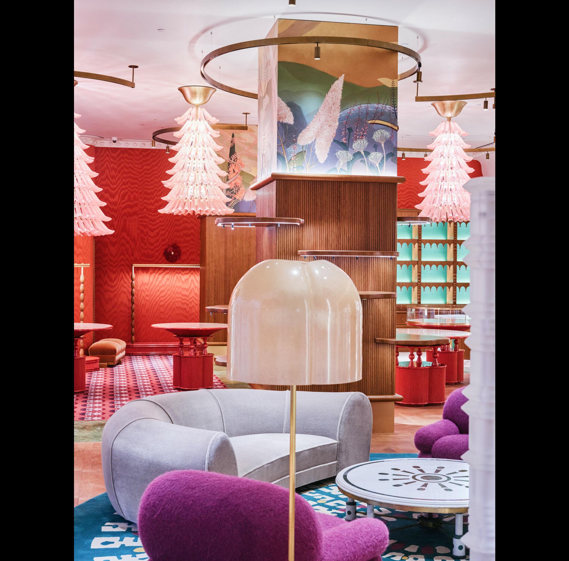 Colorful retail lounge with sculptural pink chandeliers and plush seating