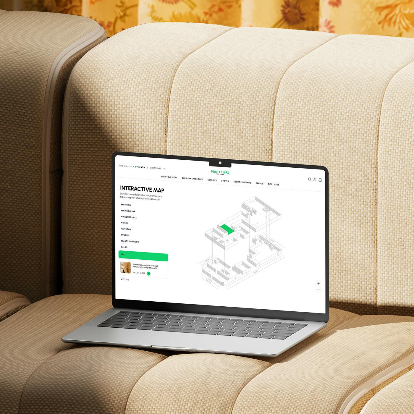 Laptop on a beige sofa showing an interactive store map