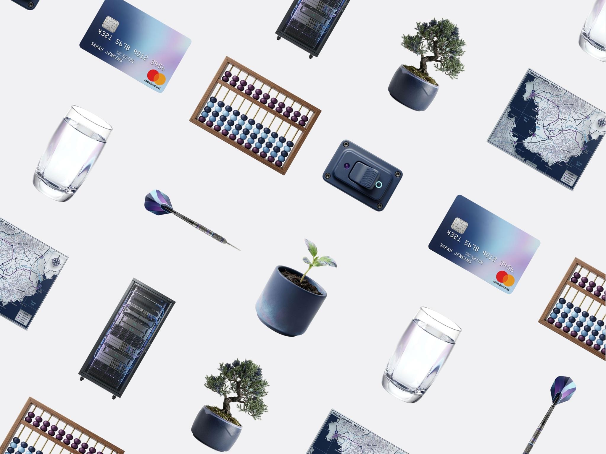 Flat lay of tech accessories, cards, glasses, and small plants