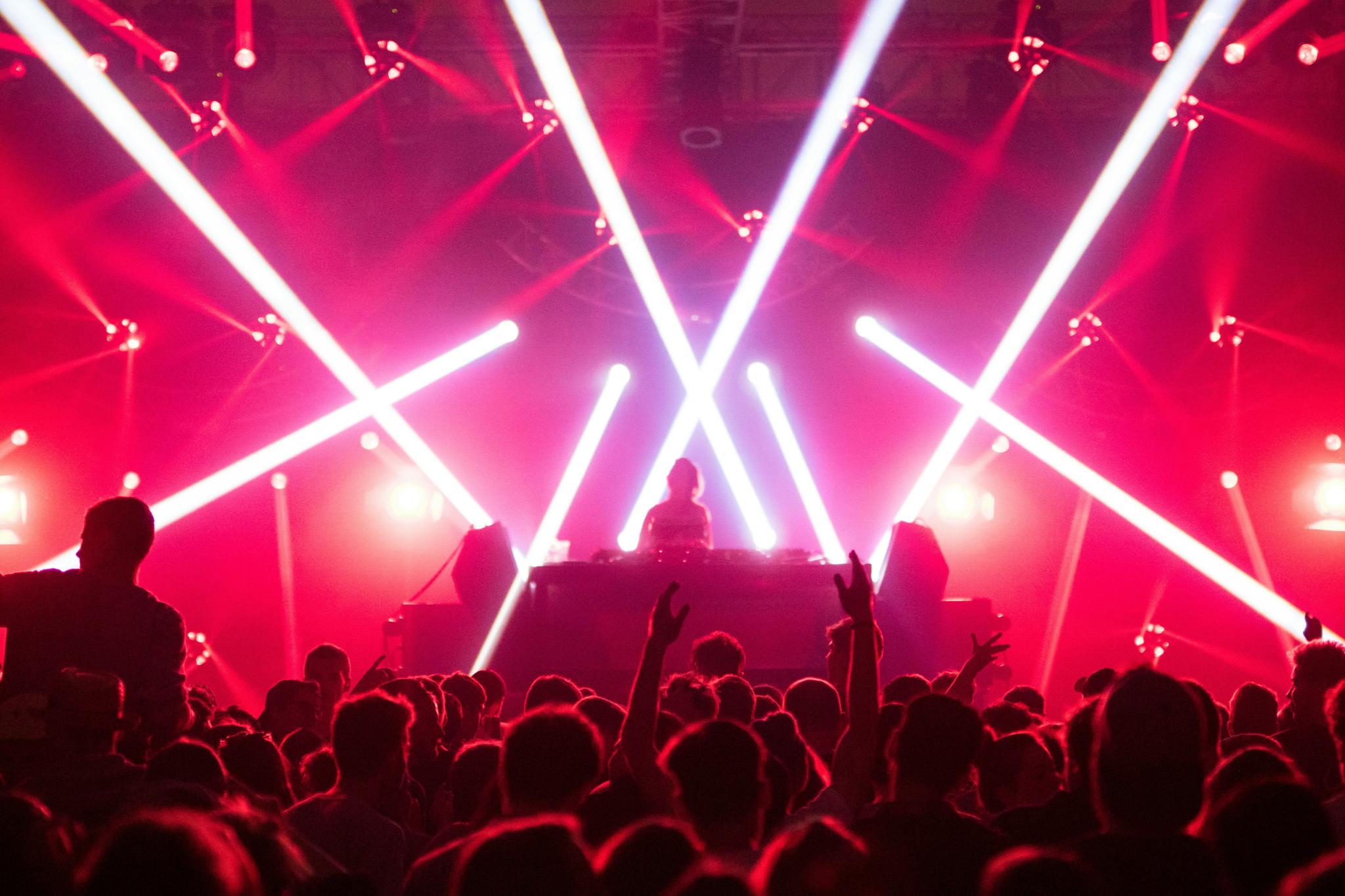 Concert crowd under red laser lights