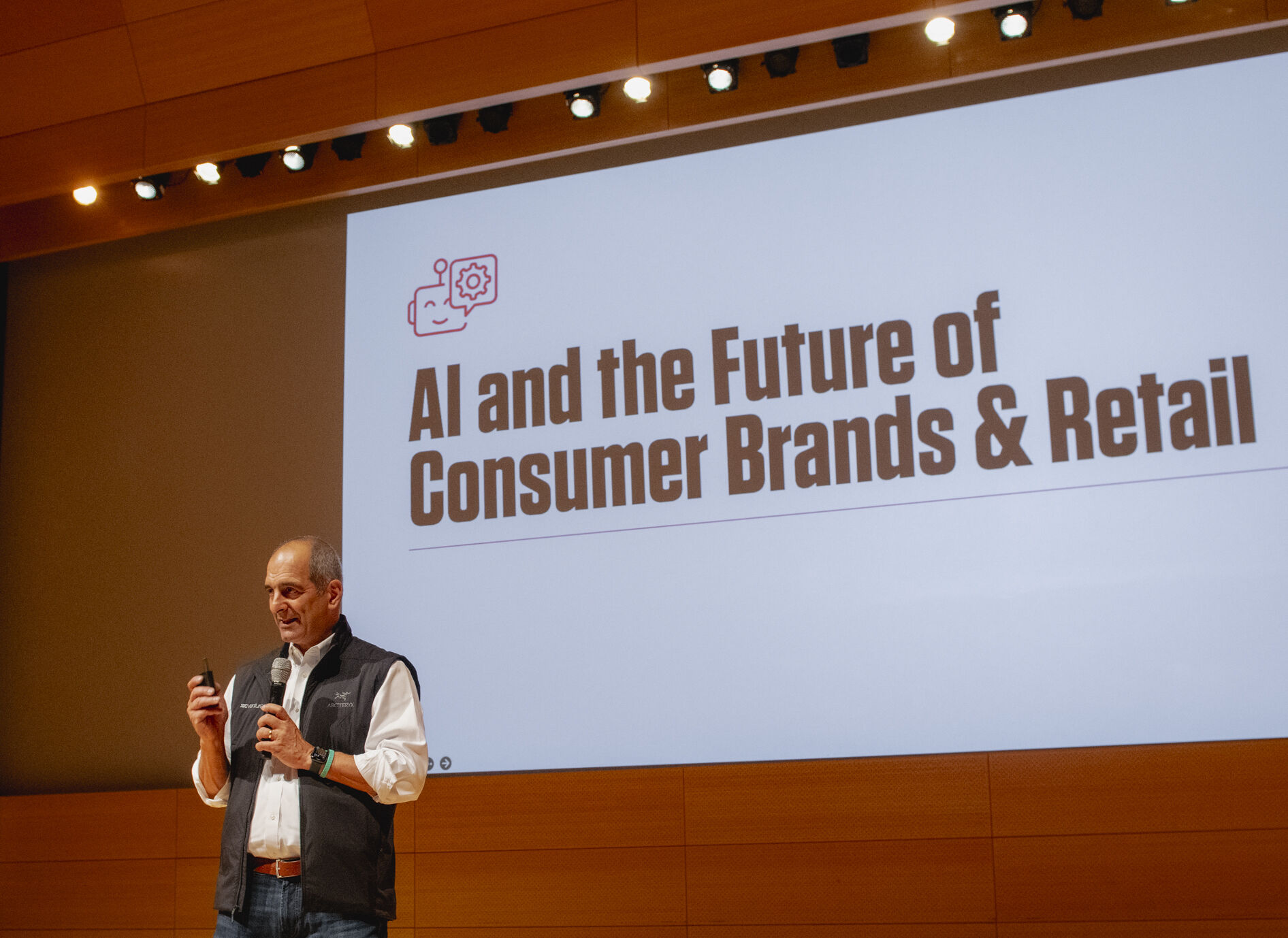 Speaker presenting slide titled AI and the Future of Consumer Brands & Retail