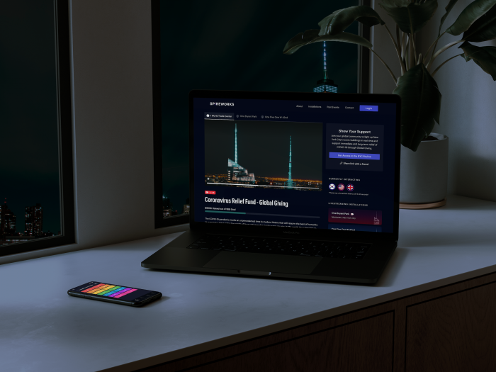 Laptop on a desk showing a donation website at night