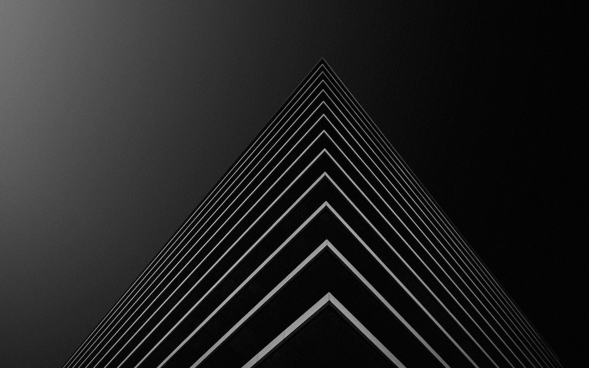 Black background with thin white nested triangular lines
