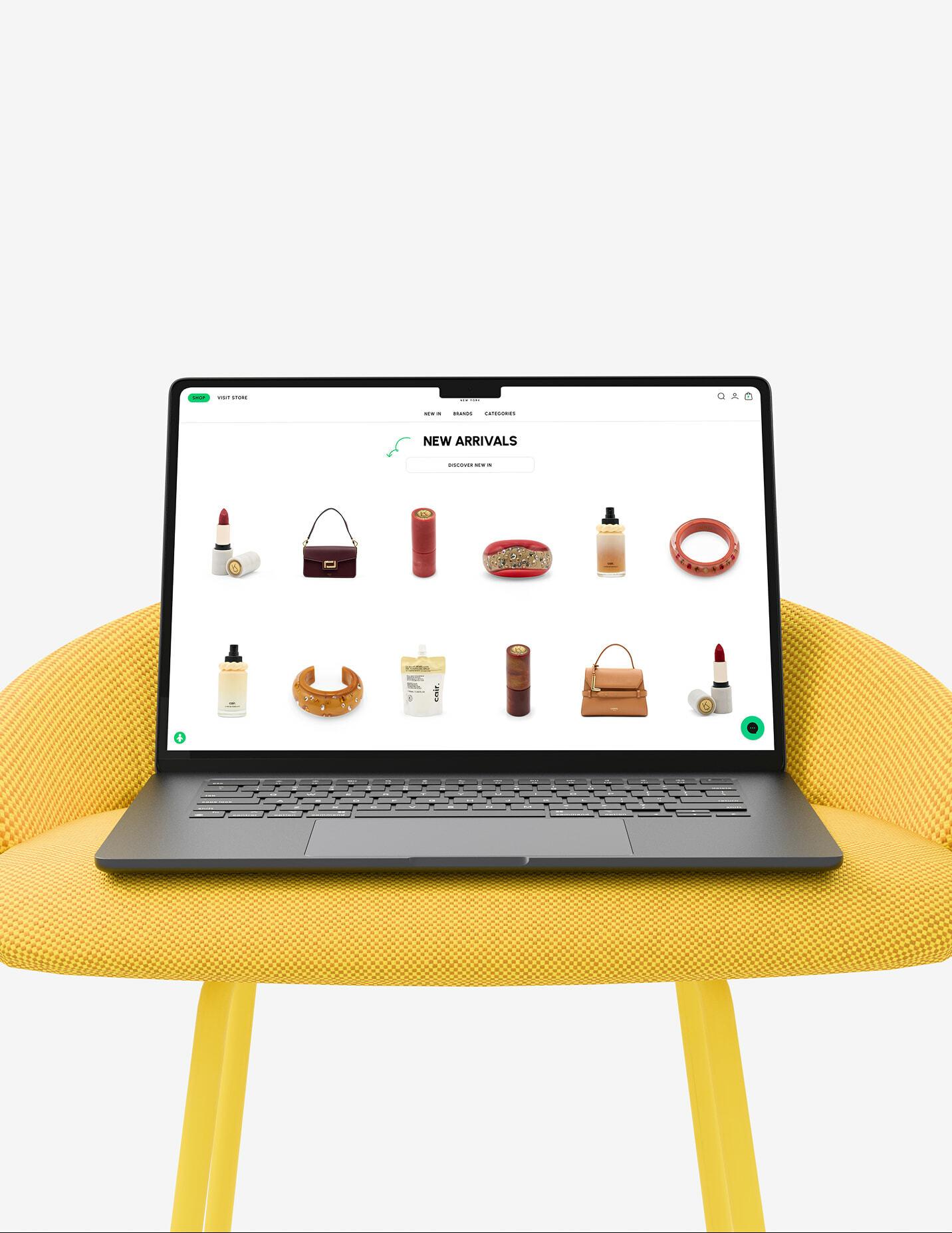 Laptop on a yellow chair showing Printemps new arrivals with beauty and fashion items