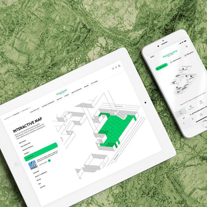 Tablet and phone showing an interactive map on a green marble surface