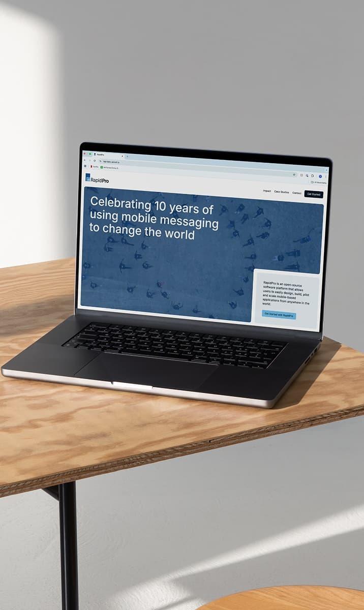 Laptop close-up showing RapidPro website headline about mobile messaging