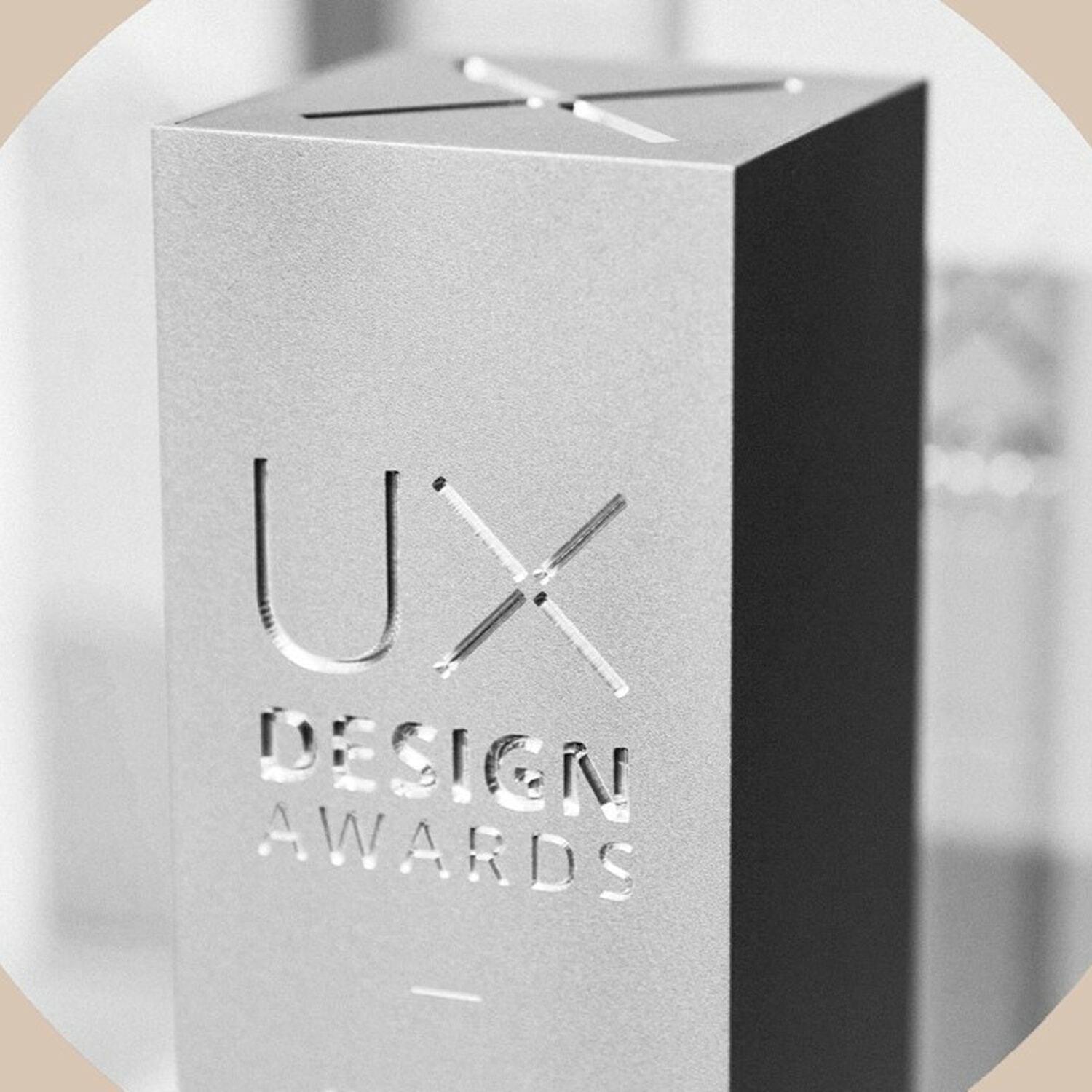 Close-up of a silver UX Design Awards trophy