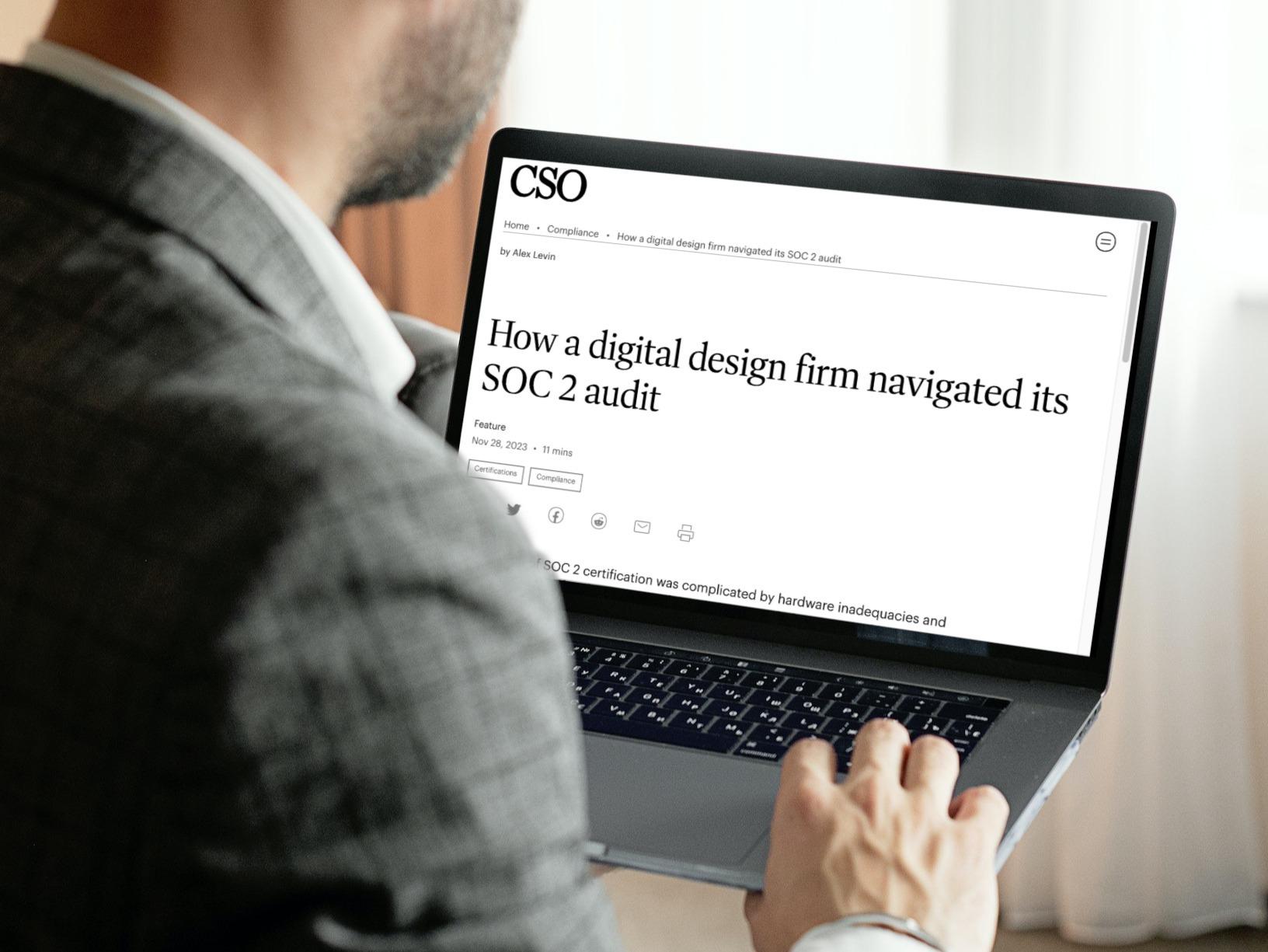 Person using a laptop showing a CSO article about a SOC 2 audit