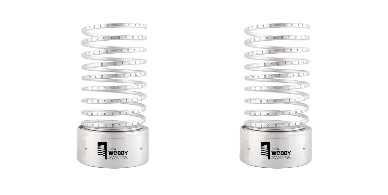 Two silver Webby Awards spiral trophies on a white background