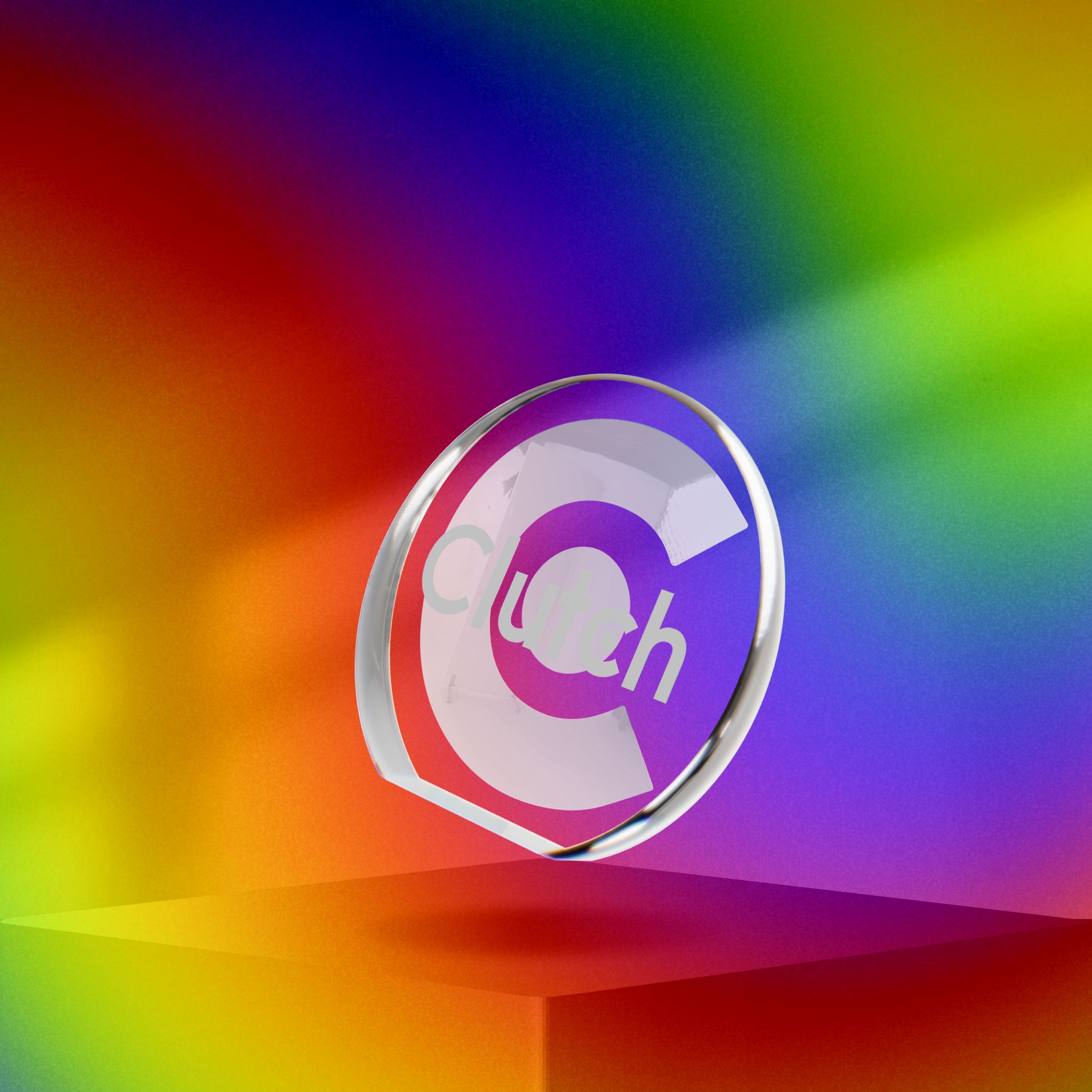 Clutch glass award on a pedestal against a rainbow gradient