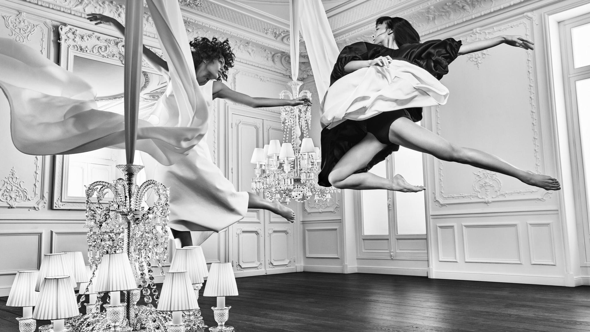 Black-and-white dancer leaping in an ornate room