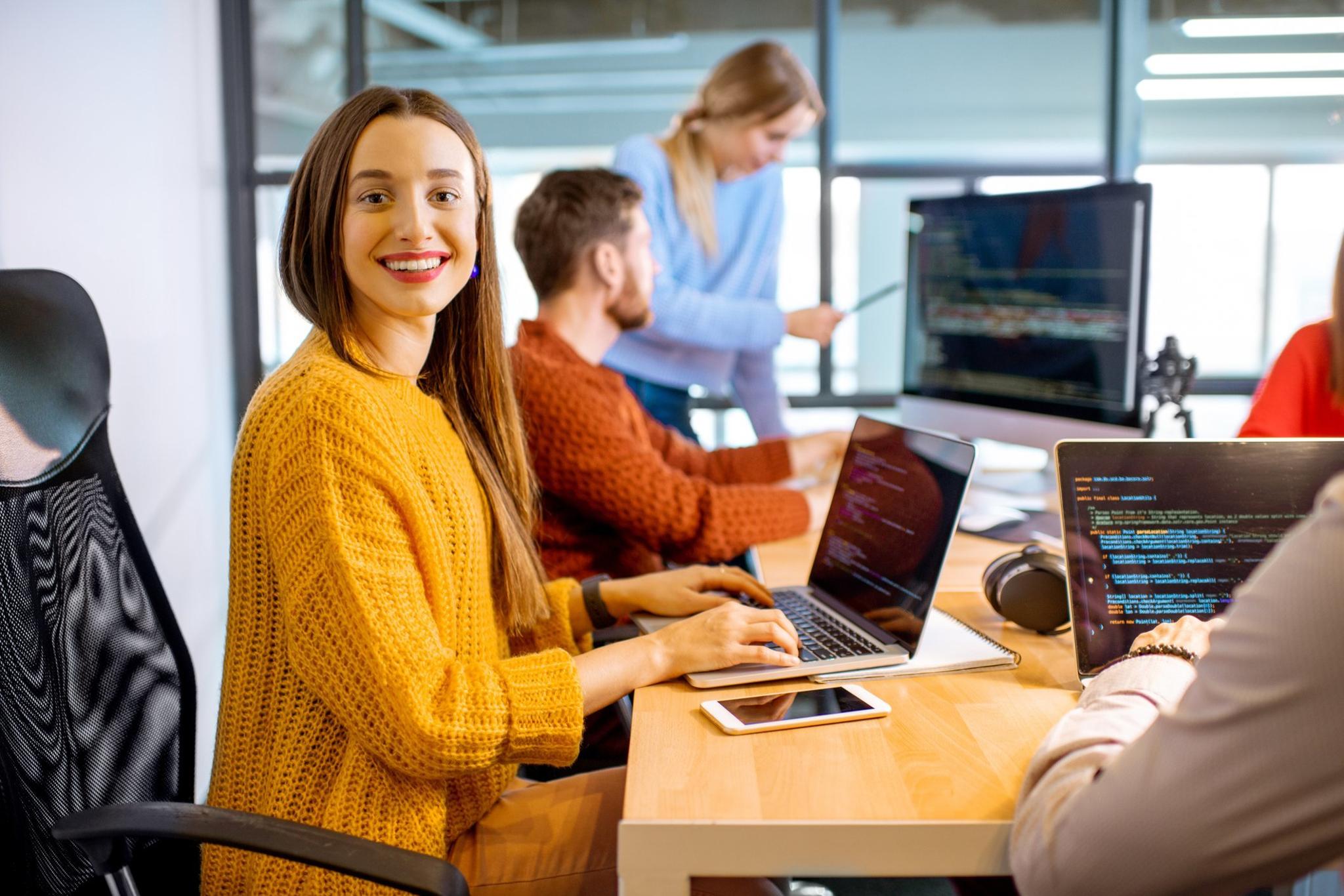 People working at laptops in a modern office