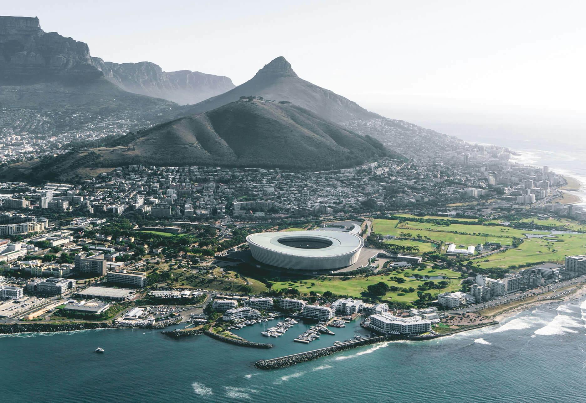 Aerial view of Cape Town coastline, stadium, and mountains