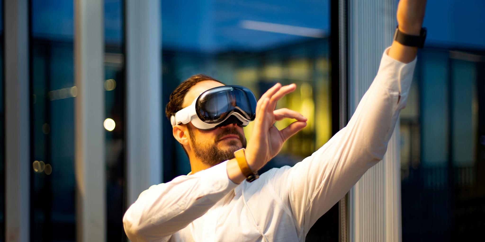 Person wearing a mixed reality headset and gesturing upward