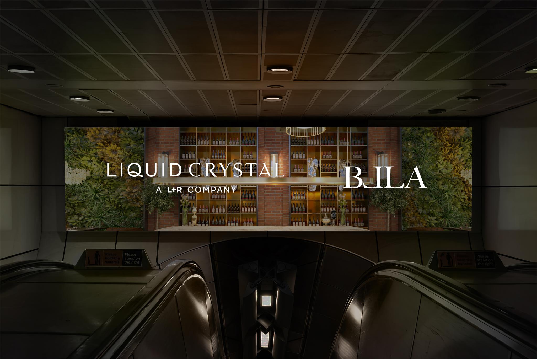 Subway escalator area with Liquid Crystal and BILA billboard on a wide digital screen