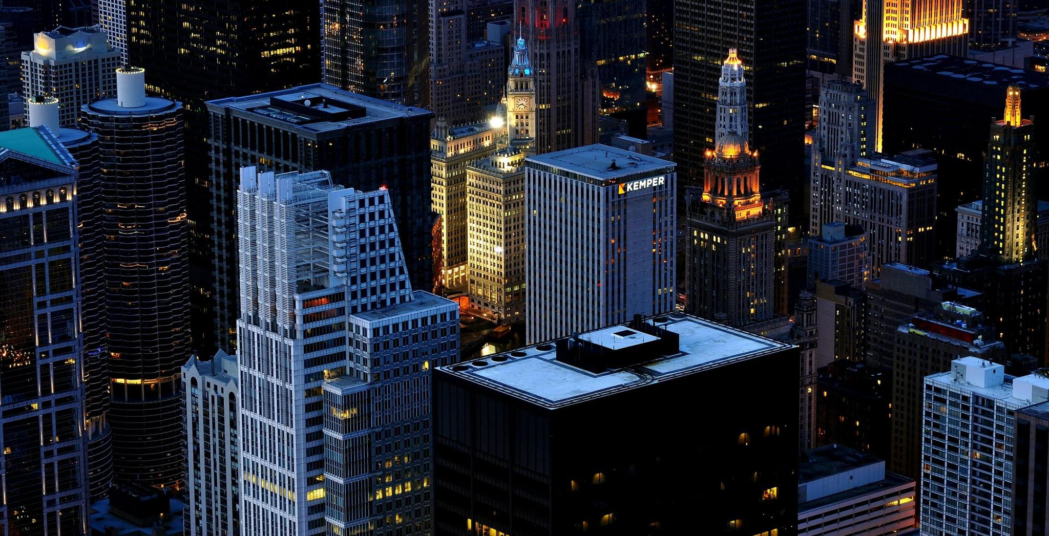 Business Desktop min Downtown city skyline at dusk with illuminated high-rise buildings