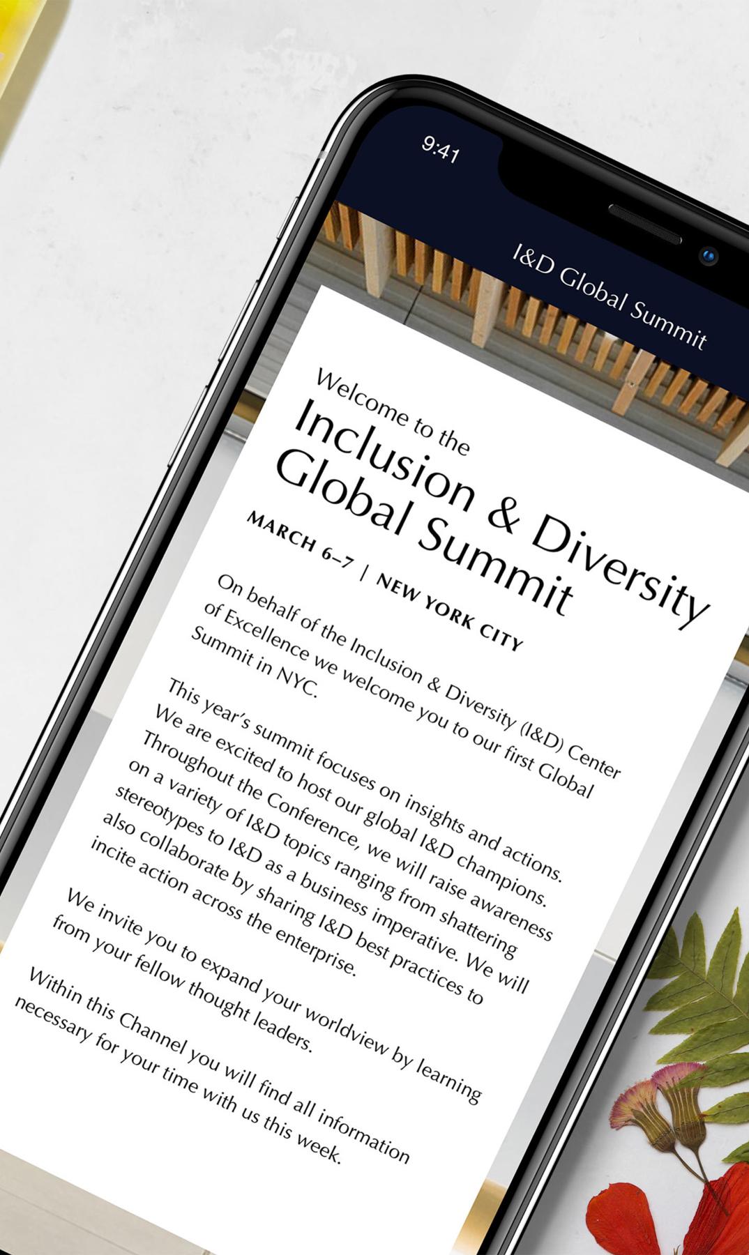Close-up phone screen showing Inclusion and Diversity Global Summit welcome text