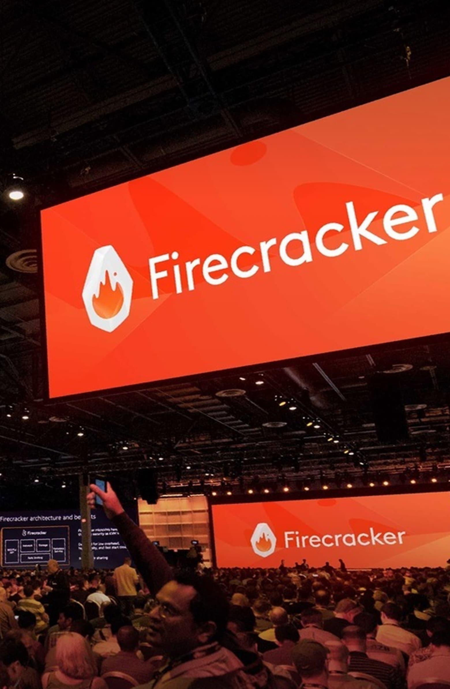 Crowded conference hall with large screens showing the Firecracker wordmark