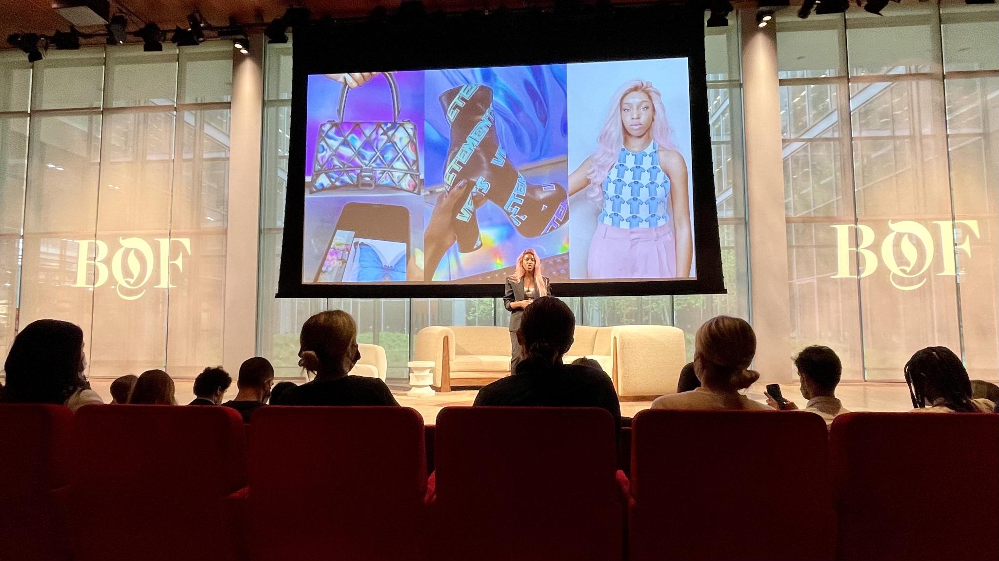 Speaker on stage presenting fashion images to an audience at a BOF event