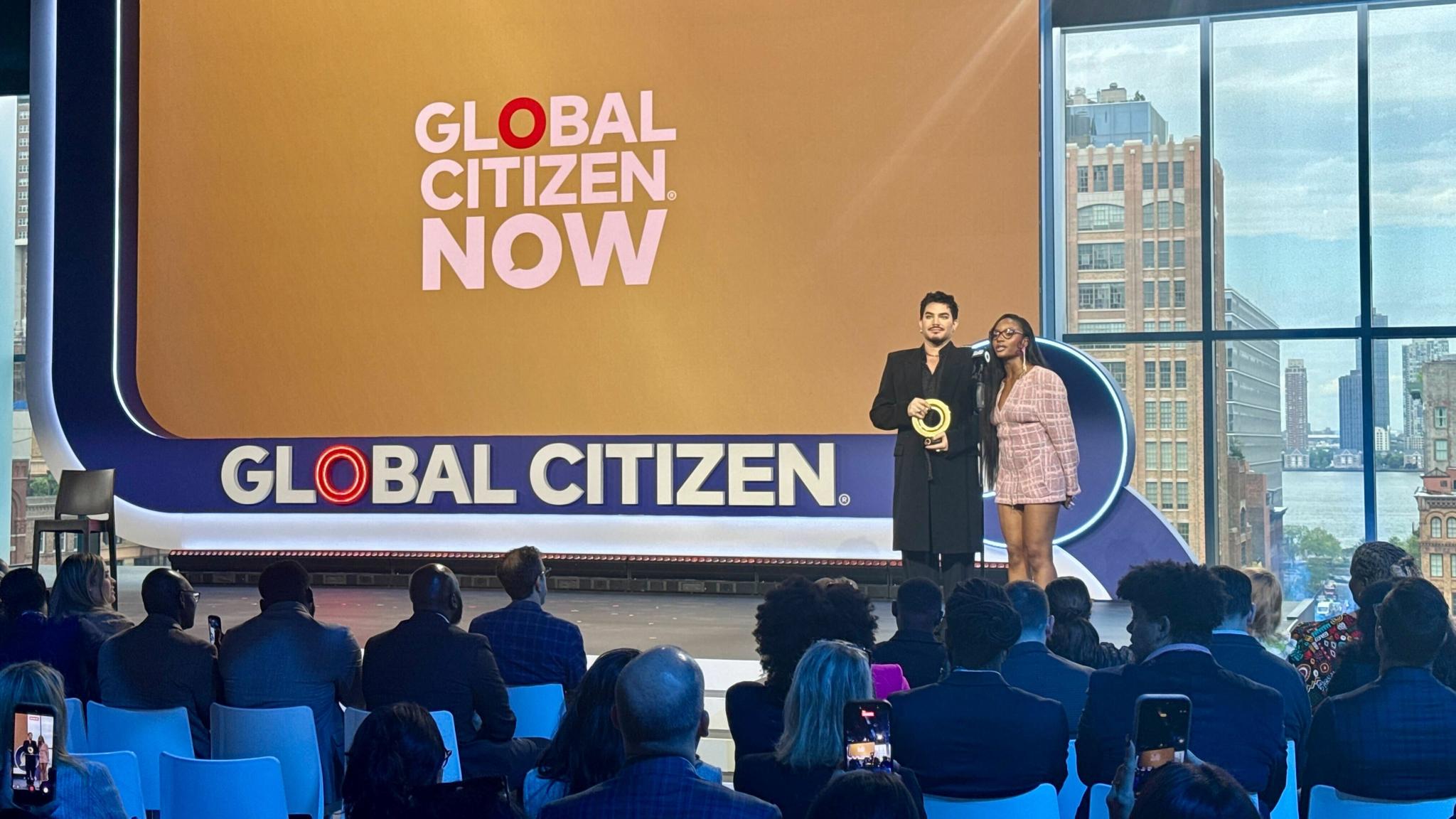 Global Citizen NOW stage with two presenters and an audience