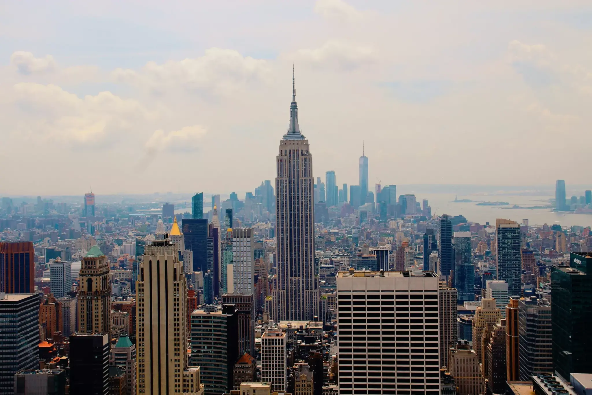 Empire State Building amid the New York City skyline under a cloudy sky