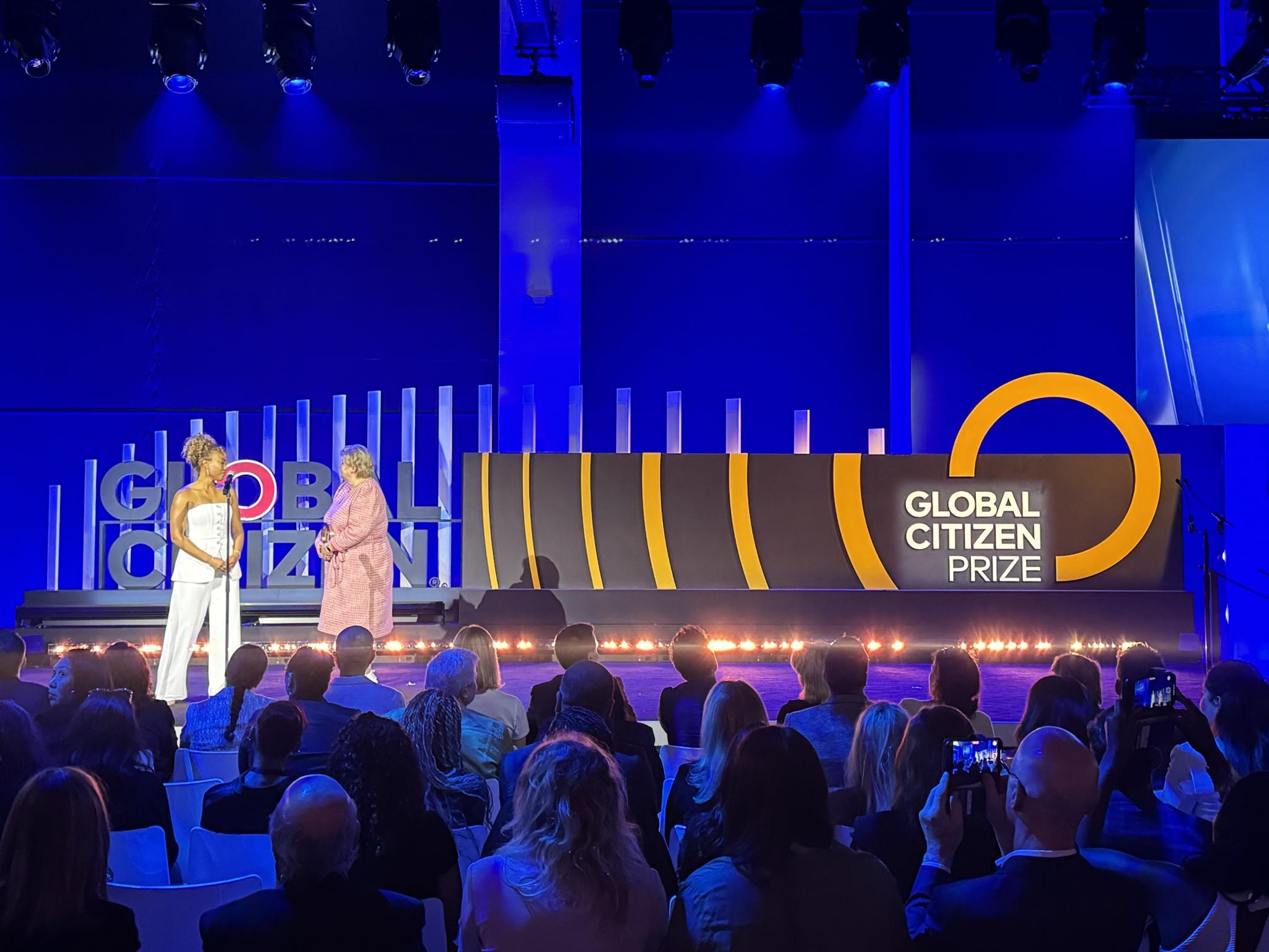 Global Citizen Prize stage with two presenters and seated audience