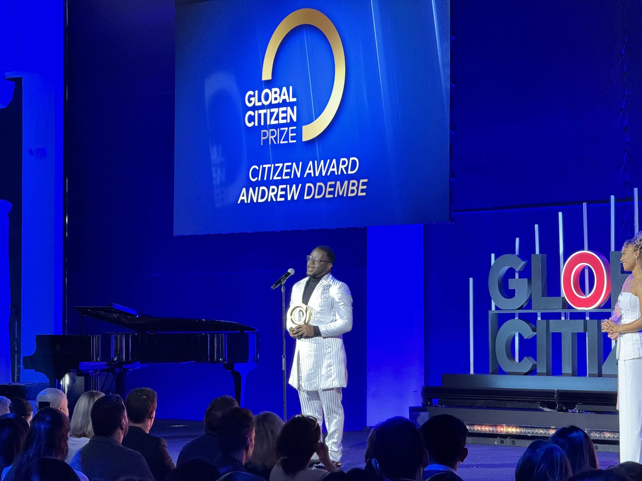 Andrew Ddembe accepting Citizen Award on Global Citizen Prize stage