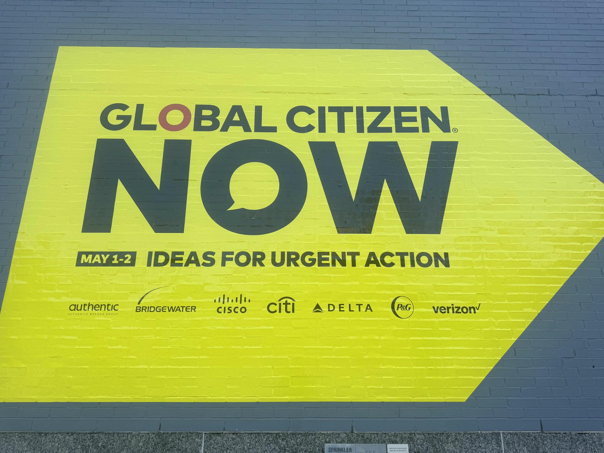 Yellow wall sign reading "Global Citizen NOW: Ideas for Urgent Action"